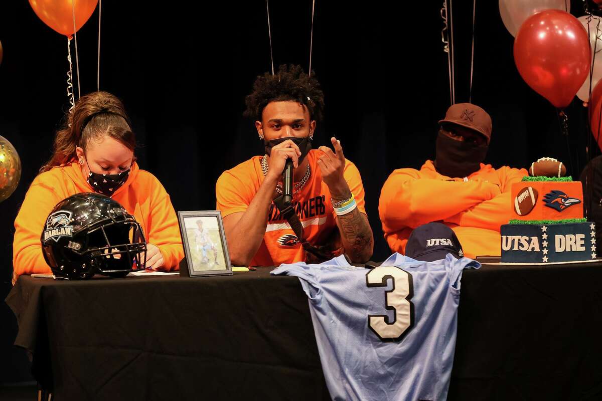 Harlan High School wide receiver Dre Spriggs speaks while seated beside his parents, Erica and Shalaby Spriggs, before signing with UTSA during a ceremony in the school's auditorium on Wednesday, Feb. 3, 2021.