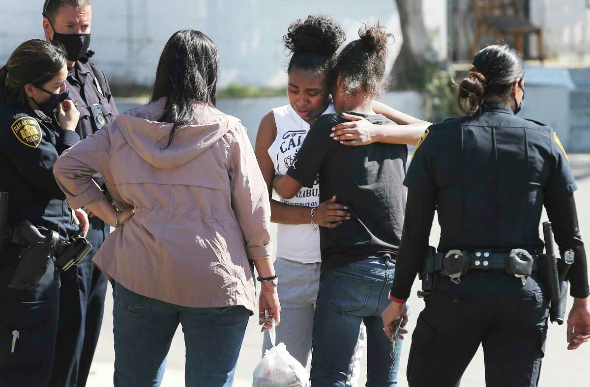 Danielle Calderon, center, is consoled by Nina Ditsch after Calderon surrendered her 6-week-old daughter to Child Protective Services after they were found living in a tent in a homeless camp under Interstate 37 east of downtown San Antonio on Wednesday, Feb. 3, 2021. About 75 to 100 people were displaced after a crew from the state Department of Transportation brought in heavy equipment and a long trailer to haul away tents and other belongings that had been left.
