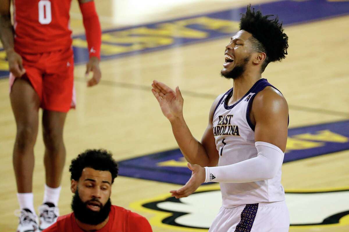 East Carolina's Jayden Gardner (1) starts to celebrate during the closing minutes of the second half of an NCAA college basketball game against Houston in Greenville, N.C., Wednesday, Feb. 3, 2021. (AP Photo/Karl B DeBlaker)