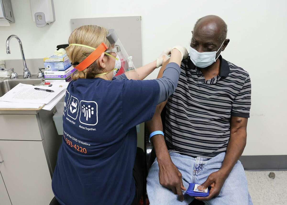 Donald Henderson gets his first dose of the COVID-19 vaccine at HOPE Clinic in Houston on Saturday, Jan. 30, 2021.