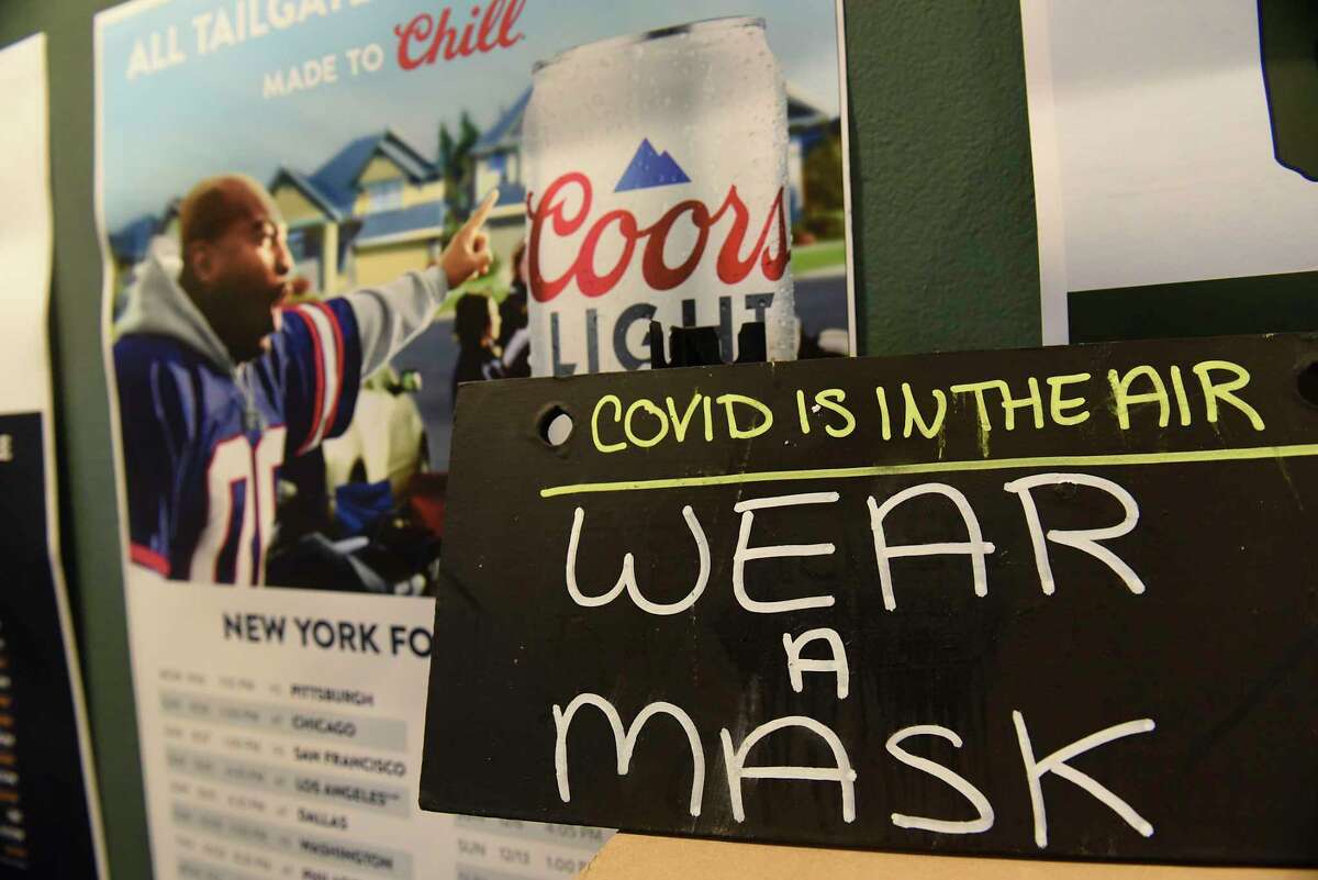 A sign to remind patrons to wear a mask is seen in Junior's Bar and Grill on Thursday, Feb. 4, 2021 in Albany, N.Y. Junior's will be open for the Super Bowl. As of May 16, 2021, New York was still requiring mask-wearing indoors - despite the CDC's May 13 ruling that vaccinated people can go maskless.  (Lori Van Buren/Times Union)