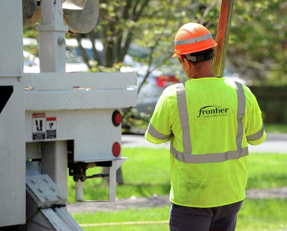 Frontier workers place a new pole on Reid Street in Fairfield, Conn. on Tuesday, May 10, 2016. Frontier provides high-speed Internet, video, TV & phone services.