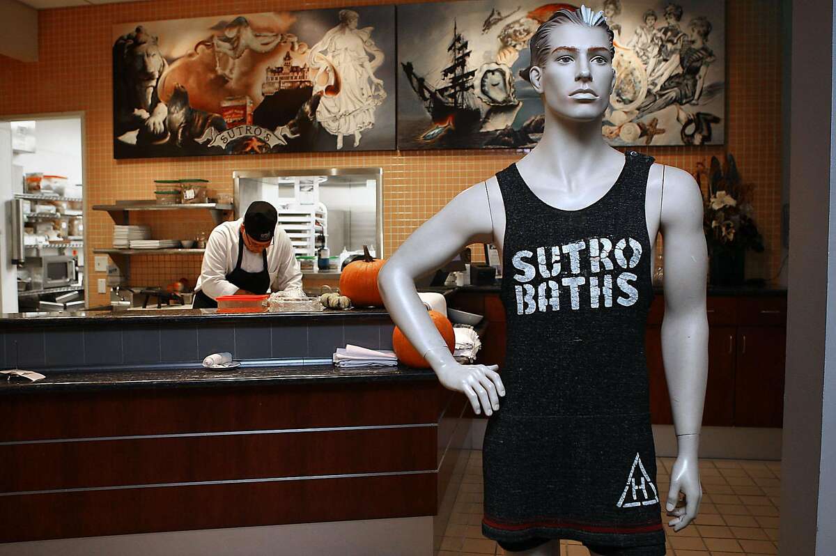 A mannequin wearing a sutro bathing suit as garde manger Carlos Sandhu-Gonzalez (left) makes croutons at Sutro's in the Cliff house in San Francisco, Calif., on Thursday, November 10, 2011. The bathing suit along with numerous other items stolen from the shuttered restaurant were recently recovered following a burglary.