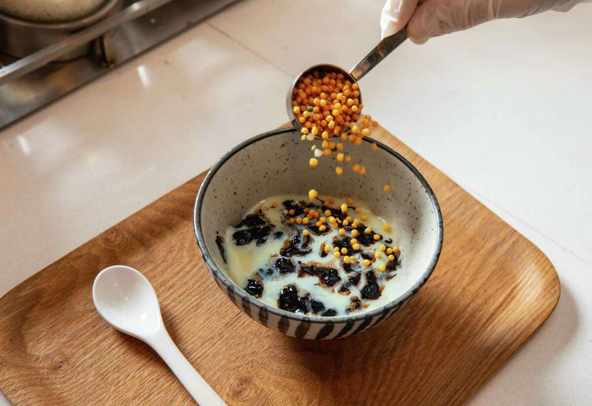 Carol Gancia makes cacao porridge at Kokak Chocolates in San Francisco's Castro district on Wednesday, February 3, 2021.