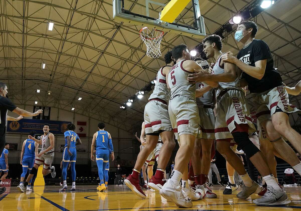 Stanford forward Oscar da Silva, second from right, celebrates with teammates after scoring in overtime for a victory in an NCAA college basketball game against UCLA in Santa Cruz on Jan. 23.