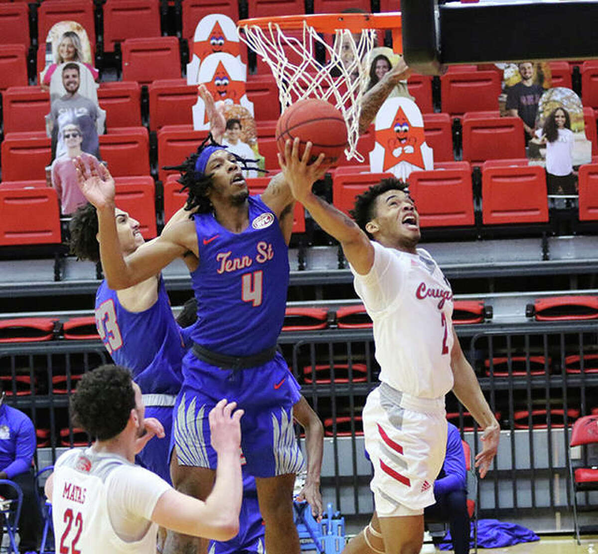SIUE’s Desmond Polk (right) gets off a reverse layup beyond the block attempt from Tennessee State’s Shakem Johnson (4) on Thursday afternoon at First Community Arena in Edwardsville.
