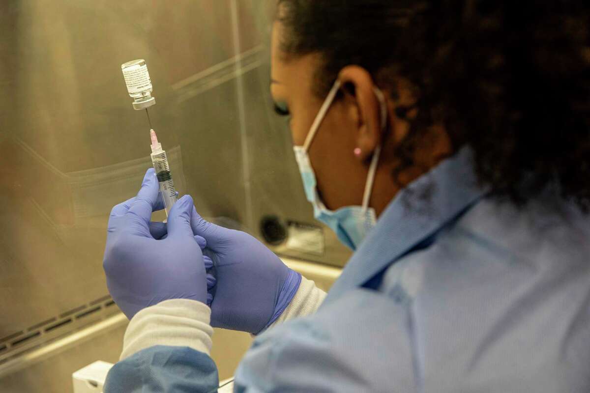 FILE -- A pharmacist in Chandler, Ariz. prepares an injection during a trial for Regeneron’s antibody treatment, Aug. 12, 2020. The Food and Drug Administration has granted emergency authorization of a COVID-19 antibody treatment made by Eli Lilly that is similar to a therapy given to President Donald Trump shortly after he contracted the coronavirus. (Adriana Zehbrauskas/The New York Times)