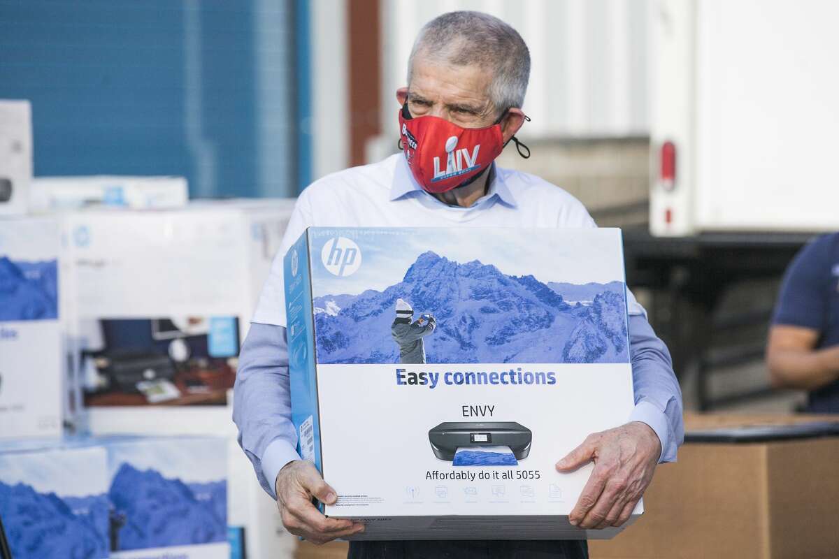 Jim "Mattress Mack" McIngvale wears a Tampa Bay Buccaneers mask during a computer giveaway on Thursday, Feb. 4.
