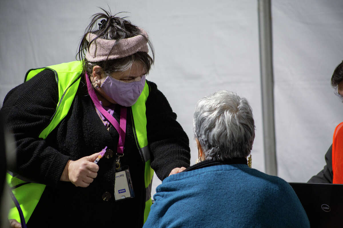Washington residents get their coronavirus vaccines through Swedish's mobile vaccination clinic set up in Federal Way.