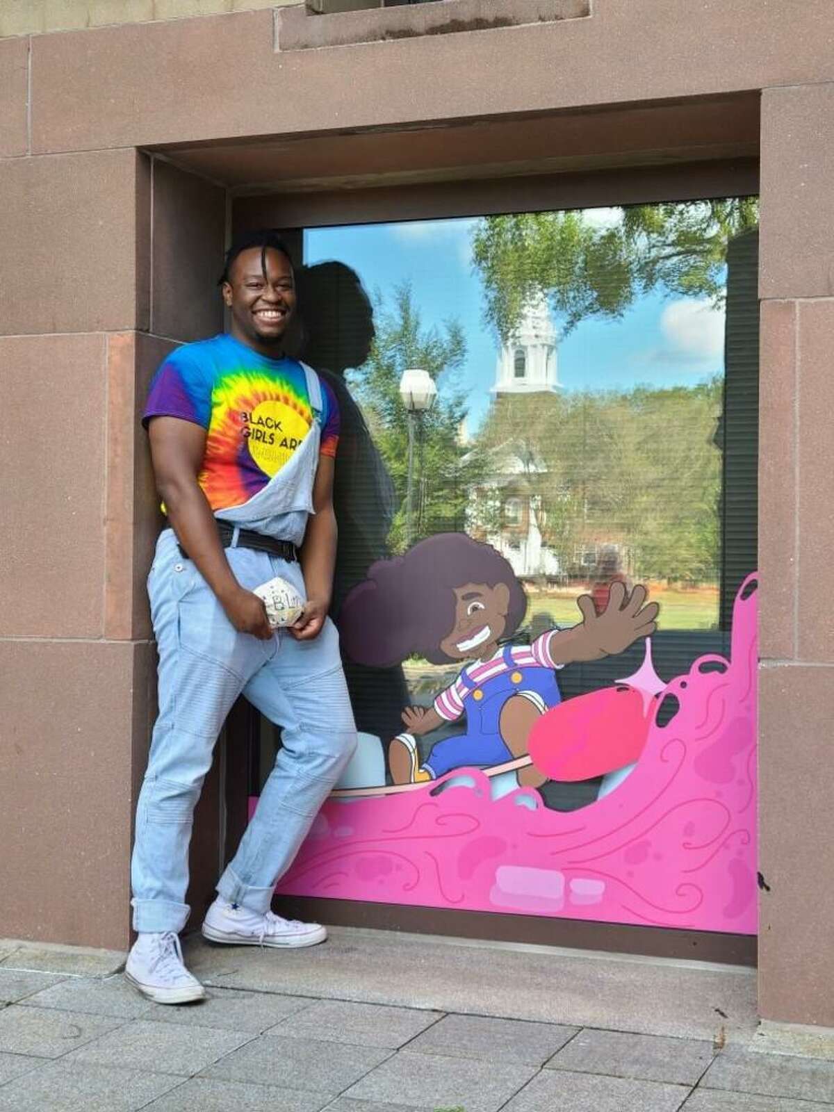 Isaac Bloodworth, a New Haven artist, with his mural Black Kid Joy at New Haven City Hall. Bloodworth will create a mural in the Hill neighborhood in 2021.