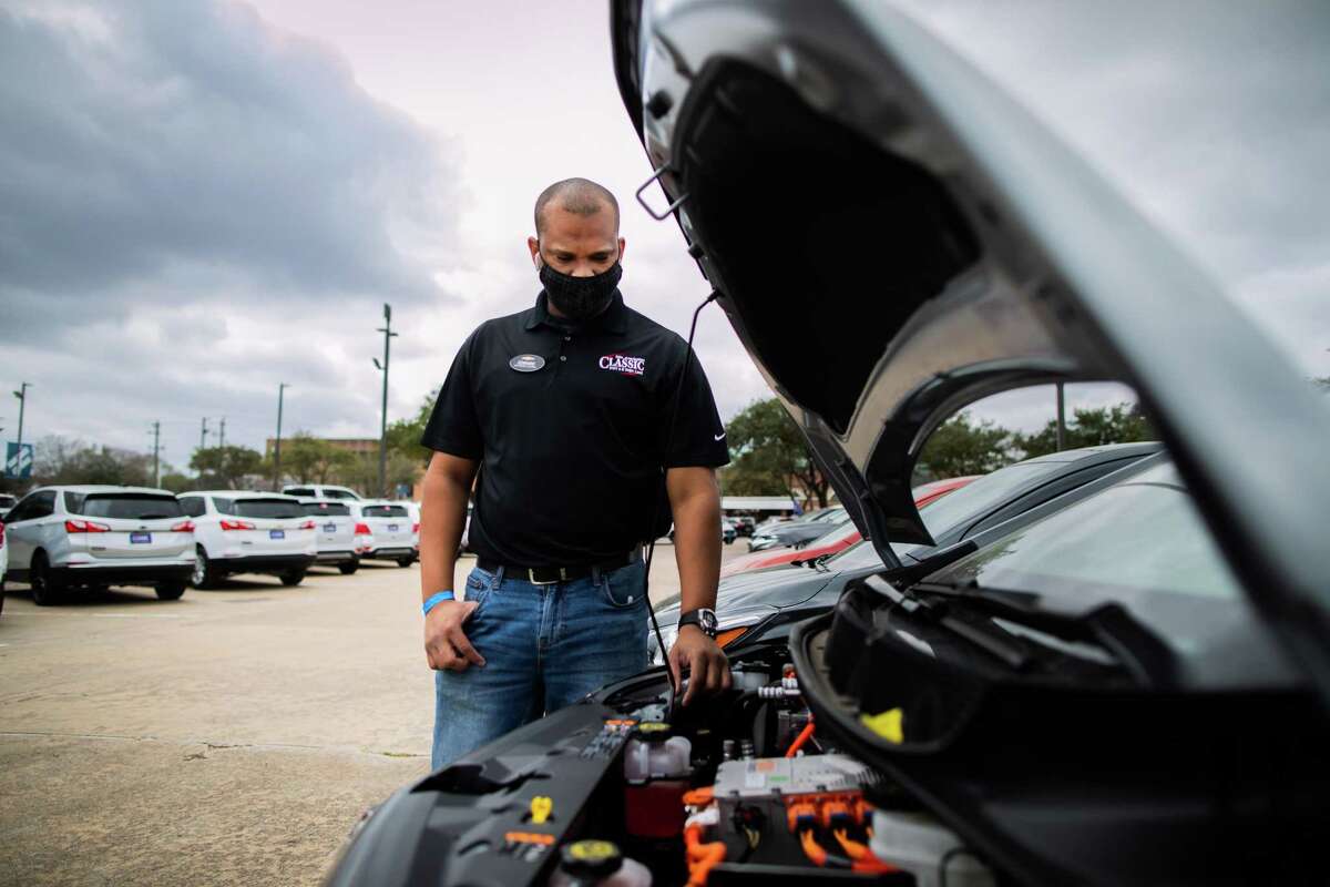 Classic Chevrolet Sugar Land sales consultant Edward Jackson Davis takes a look under the hood of a Chevrolet Bolt EV, Thursday, Feb. 4, 2021, in Sugar Land. The Bolt EV is a front-motor, five-door all-electric car.
