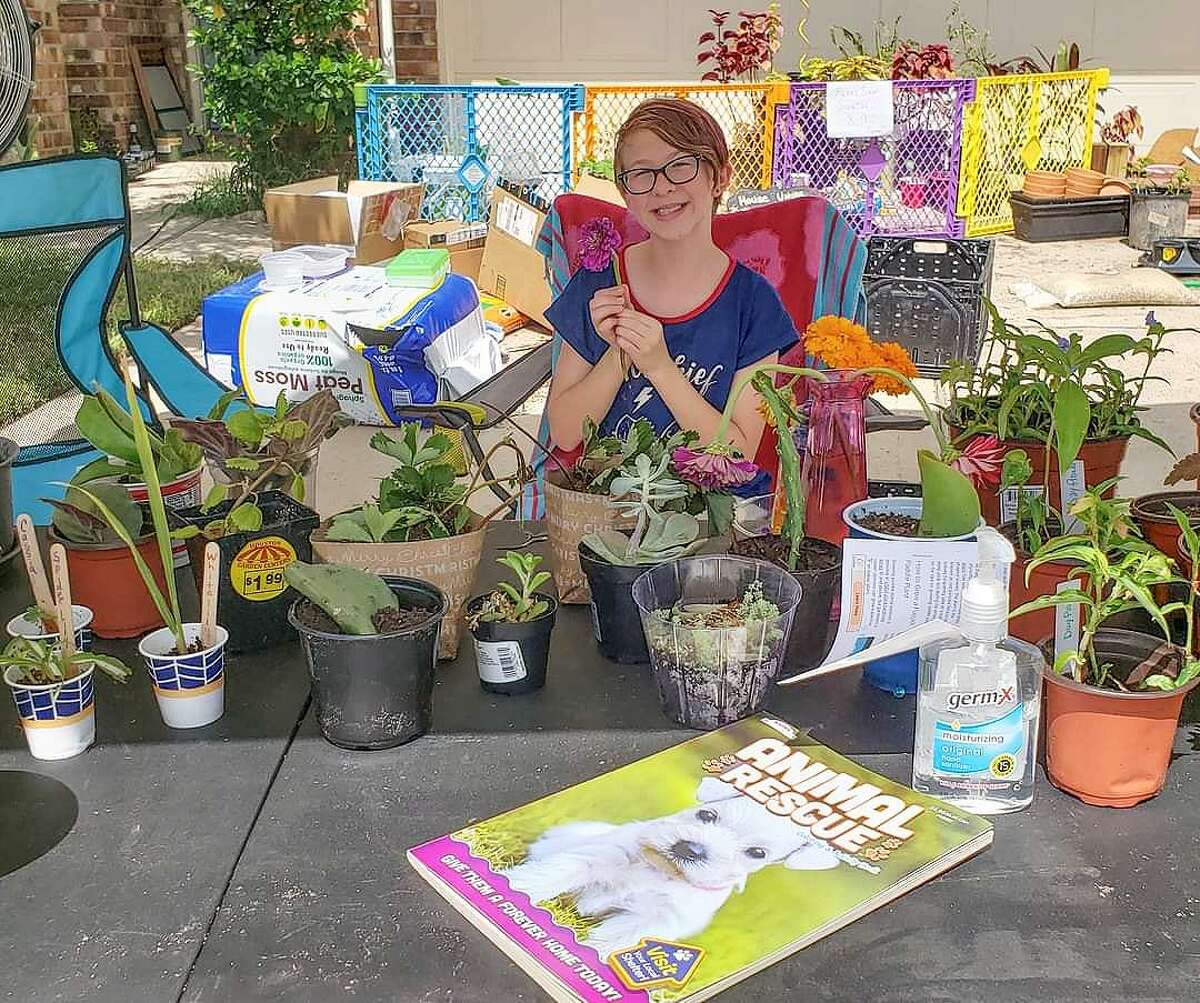 Fish has her table prepared with a variety of starter plants and items for trade at her Trade Day in September 2020.