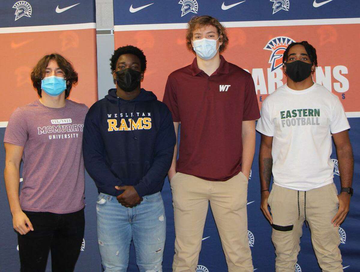 Seven Lakes football players (from left) Emilio Ramos (McMurry), Nick David-West (Texas Wesleyan), Sam Treadaway (West Texas A&M)and Milton Jones (Eastern New Mexico) celebrated National Signing Day, Feb. 3 at Seven Lakes High School.