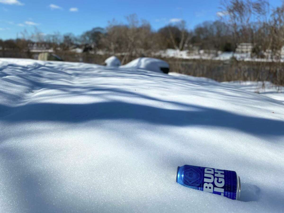 A beer can sits in the snow on the shore of Gorham’s Pond on Thursday. Friends of Gorham's Pond and neighbors implore those who use the pond to clean up after themselves.