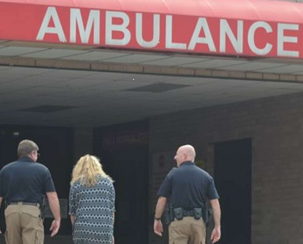 A person is escorted into the HCA Houston Healthcare Conroe emergency wing after a mental health crisis by Montgomery County Precinct 1 Constable's deputies with the county's crisis intervention team.