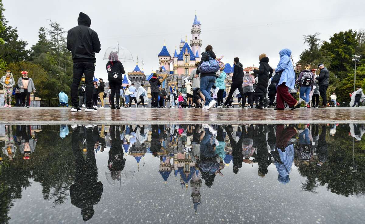 Visitors in front of Sleeping Beauty Castle on the last day before Disneyland closed because of the COVID-19 outbreak.