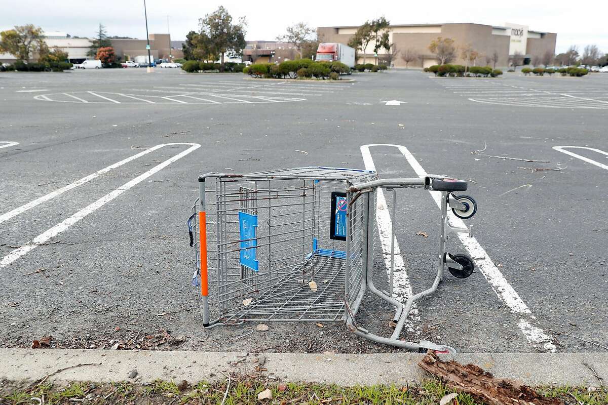A discarded Wal-Mart shopping cart at The Shops at Hilltop in Richmond, Calif., on Monday, February 1, 2021.