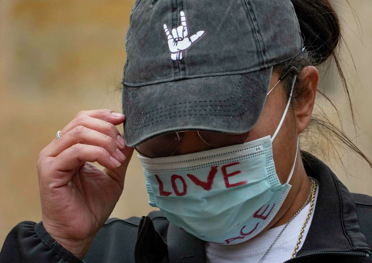 Melissa Zemault Wicker wears a mask during a vigil to remember her father, Darrell Zemault, in Main Plaza on Friday, Feb. 5, 2021. Zemault was killed by police on Sept. 15, 2019, in front of his West San Antonio home.