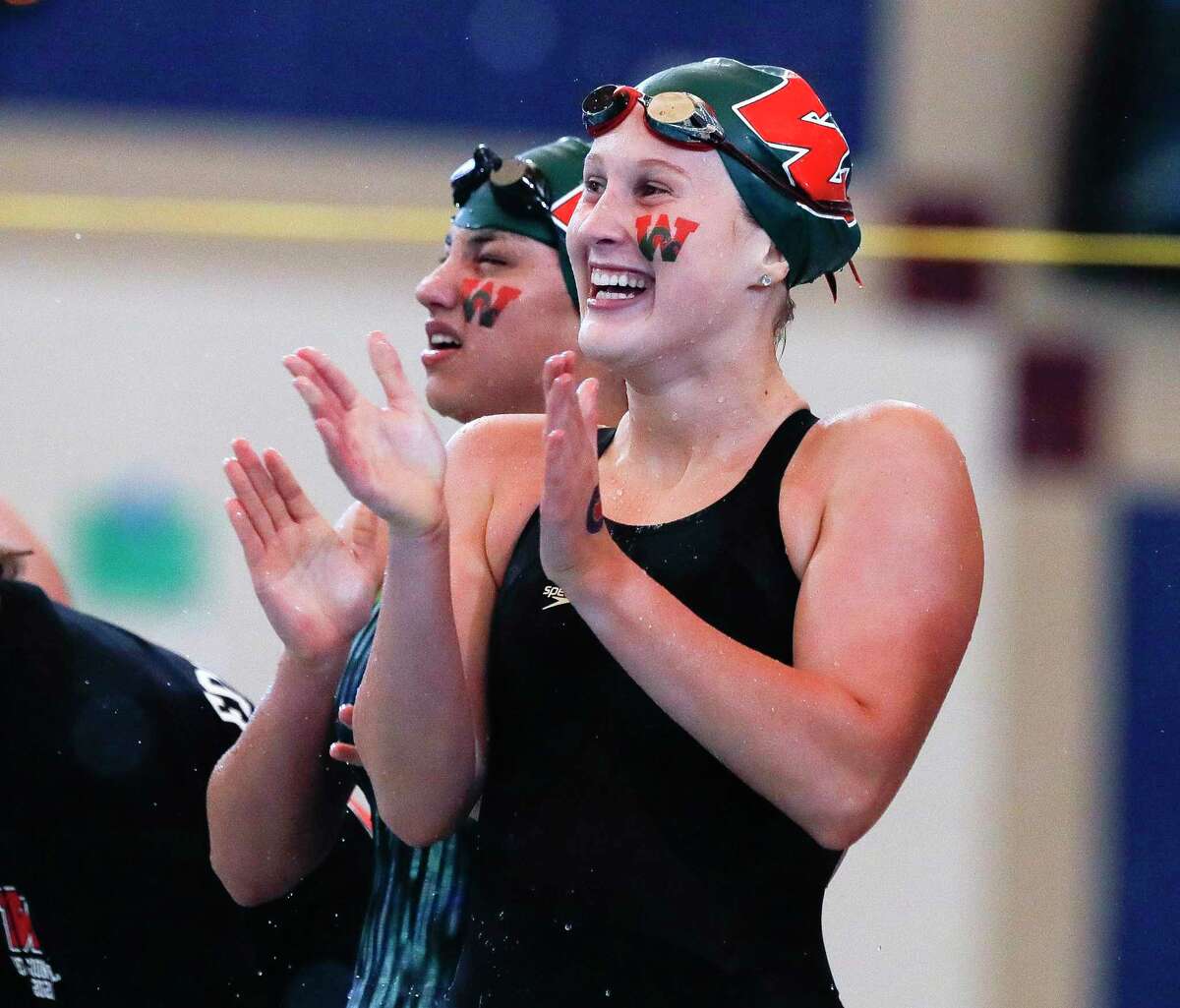 The Woodlands swimmers react after winning the girls 200-yard medley relay during the Region IV-6A Swimming & Diving Championships at the Conroe ISD Natatorium, Friday, Feb. 5, 2020, in Shenandoah.