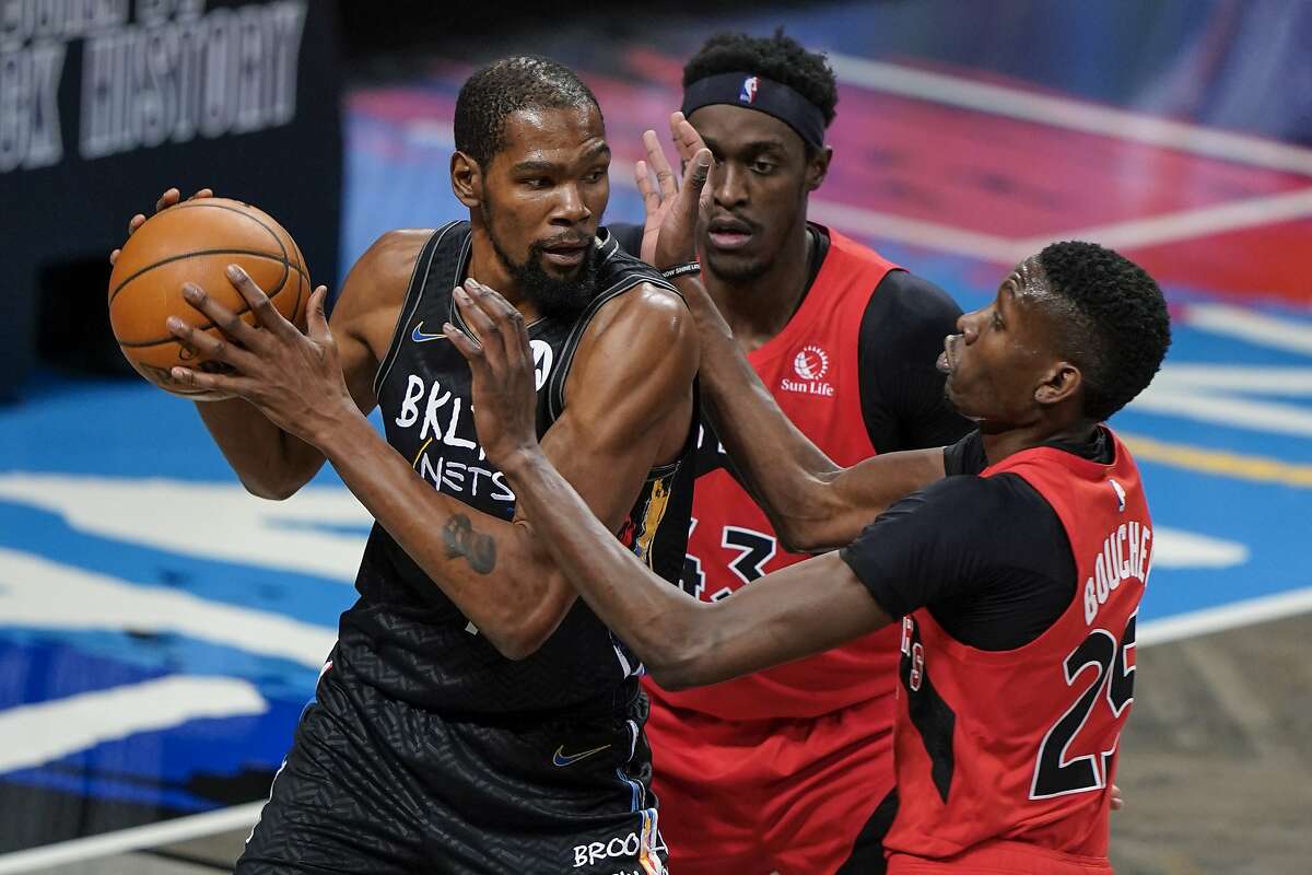 Kevin Durant (left) had eight points before being pulled in the third quarter of the Nets’ win over the Raptors.