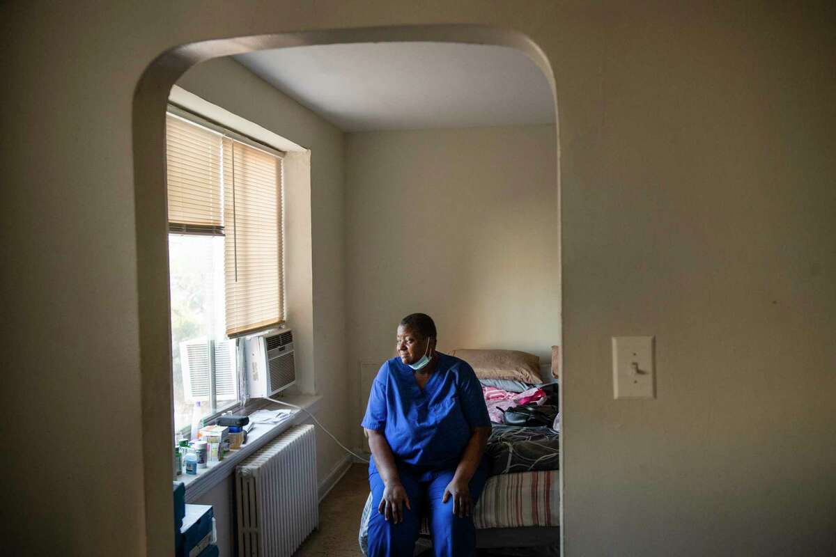 Sabrina Mosley, seen at her District of Columbia home, was forced to miss weeks of work as she recovered from covid-19.