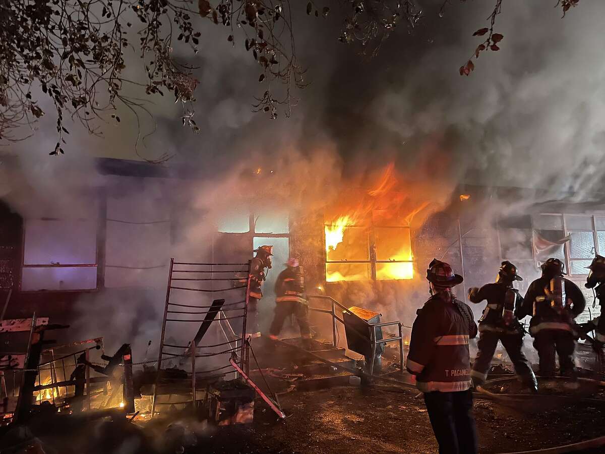 An early morning fire on Saturday that started at a homeless camp caused extensive damage to an Oakland community center.