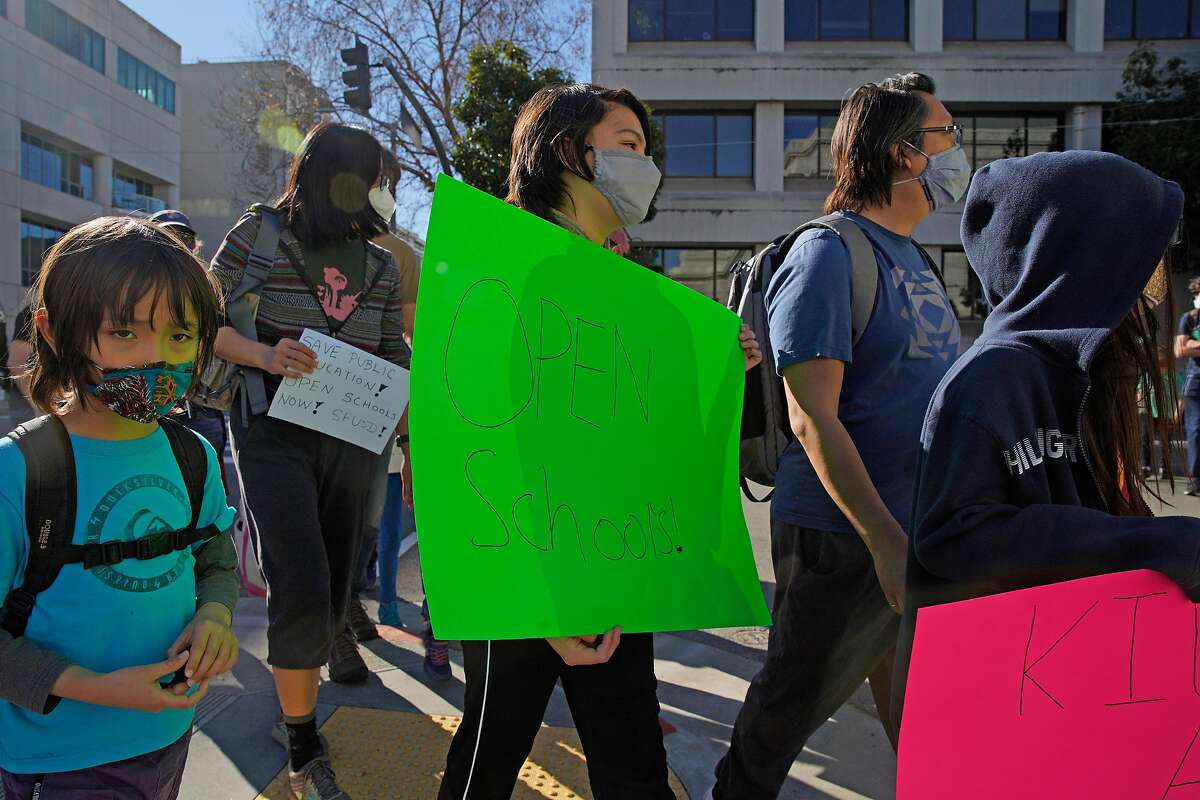 Calder Law, 12, who attends Roosevelt Middle School, marches back to City Hall after a rally outside the SFUSD building, Saturday, Feb. 6, 2021, in San Francisco, Calif. People protested against remote education and demanded schools to reopen in-person education.