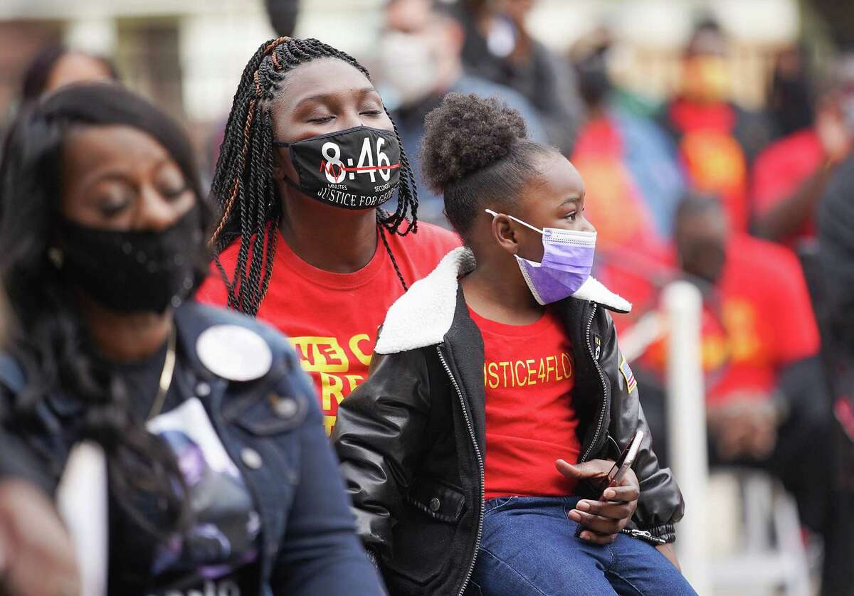 George Floyd's friends and family members listen during a Black History Month tribute to George Floyd and the Black Lives Matter movement in front of HISD’s Jack Yates High School in Houston on Saturday, Feb. 6, 2021.