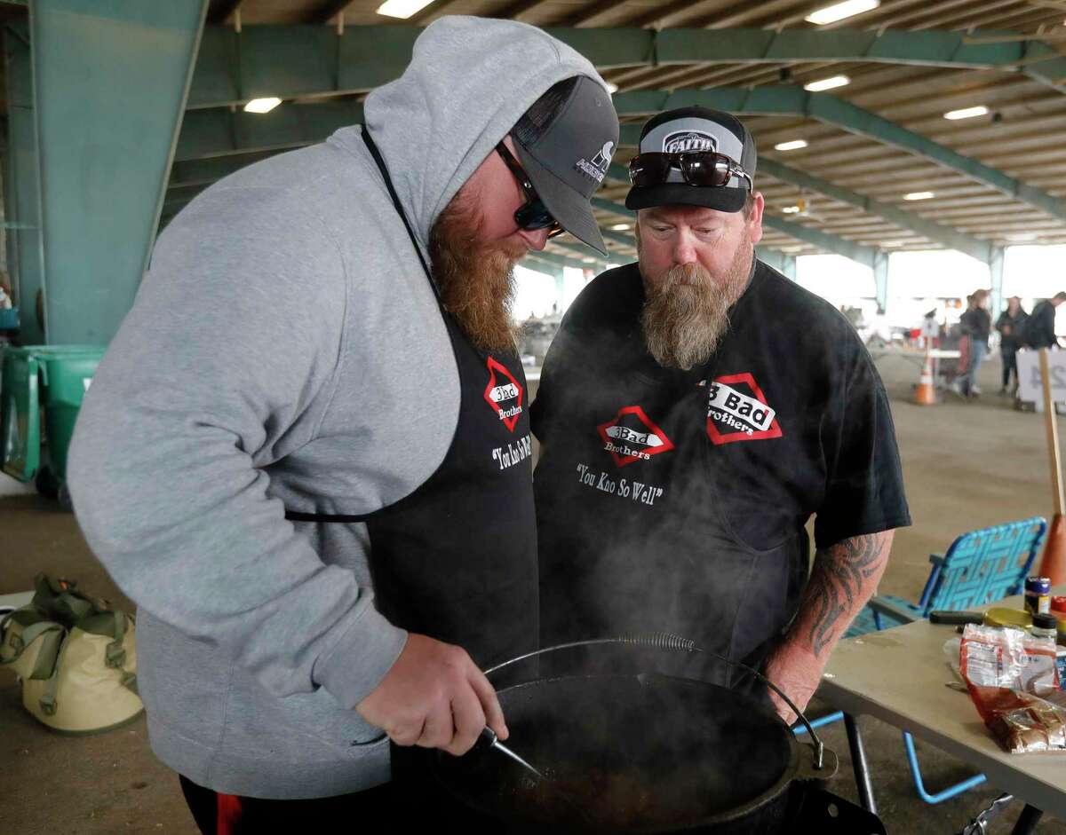 Russell Arnold, left, check his team’s chili beside his brother, Richard, during the Montgomery County Fair Association’s scholarship cook-off at the Montgomery County Fairgrounds on Saturday in Conroe.