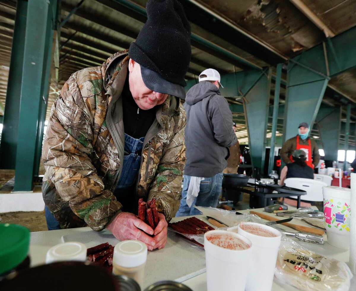 Donnie Buckalew cuts sausage during the Montgomery County Fair Association’s scholarship cook-off at the Montgomery County Fairgrounds, Saturday, Feb. 6, 2021, in Conroe.