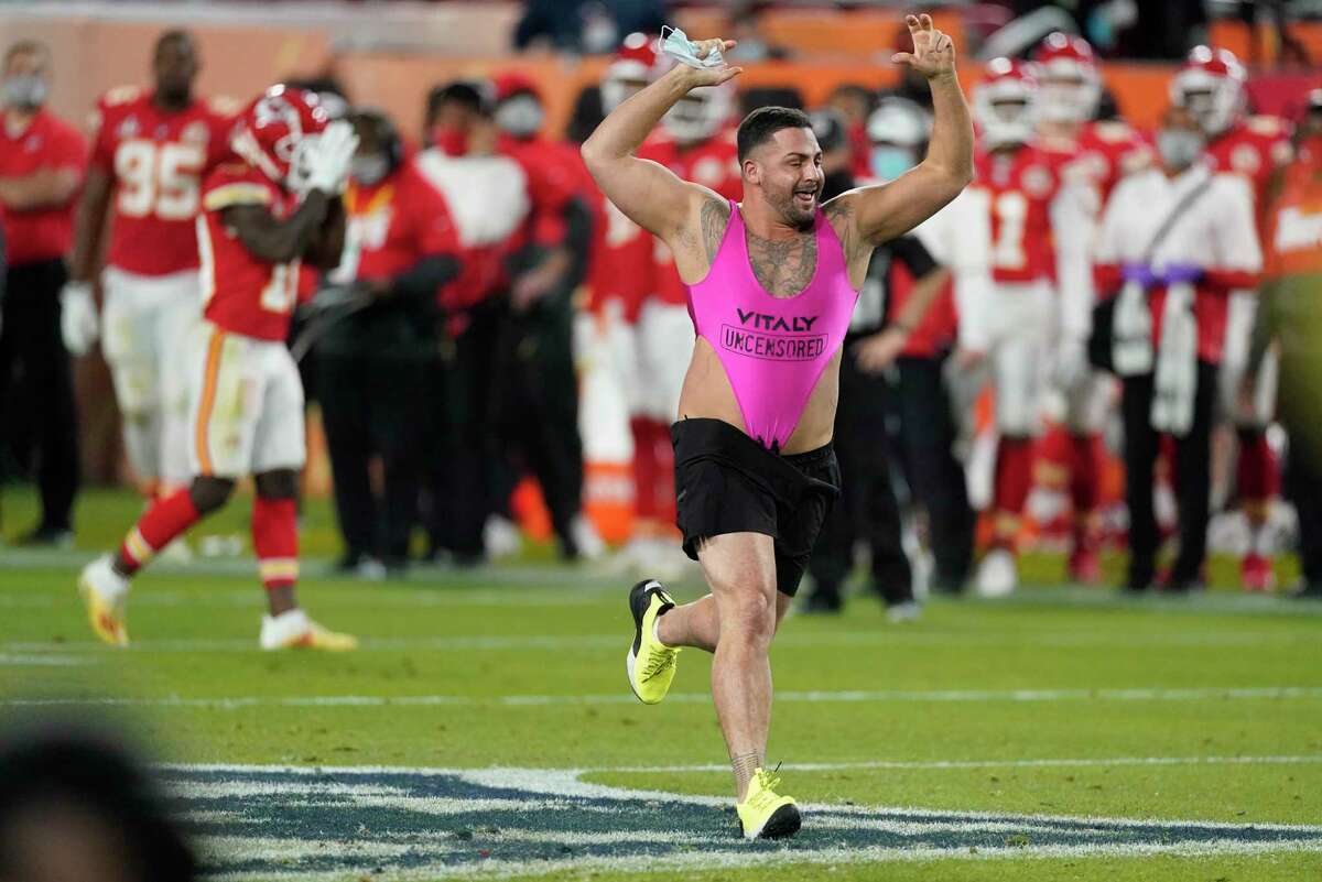 A fan runs on the field during the second half of the NFL Super Bowl 55 football game between the Tampa Bay Buccaneers and the Kansas City Chiefs, Sunday, Feb. 7, 2021, in Tampa, Fla. (AP Photo/Ashley Landis)