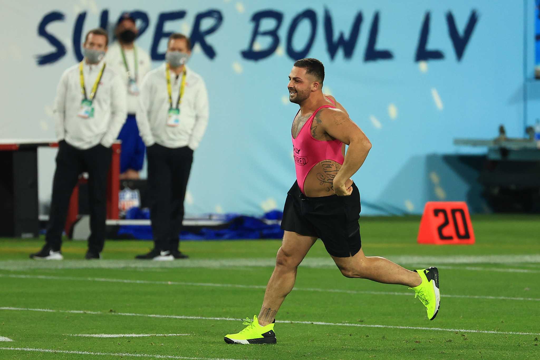 Streaker: Fan in pink one-piece runs on field during Super Bowl LV