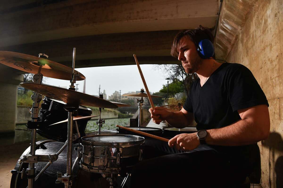 James Gemino, a New York native who recently moved to San Antonio, plays his drums underneath the Josephine Street bridge on a rainy Sunday afternoon.