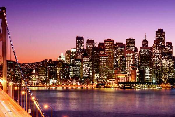 San Francisco skyline and Bay Bridge at sunset.