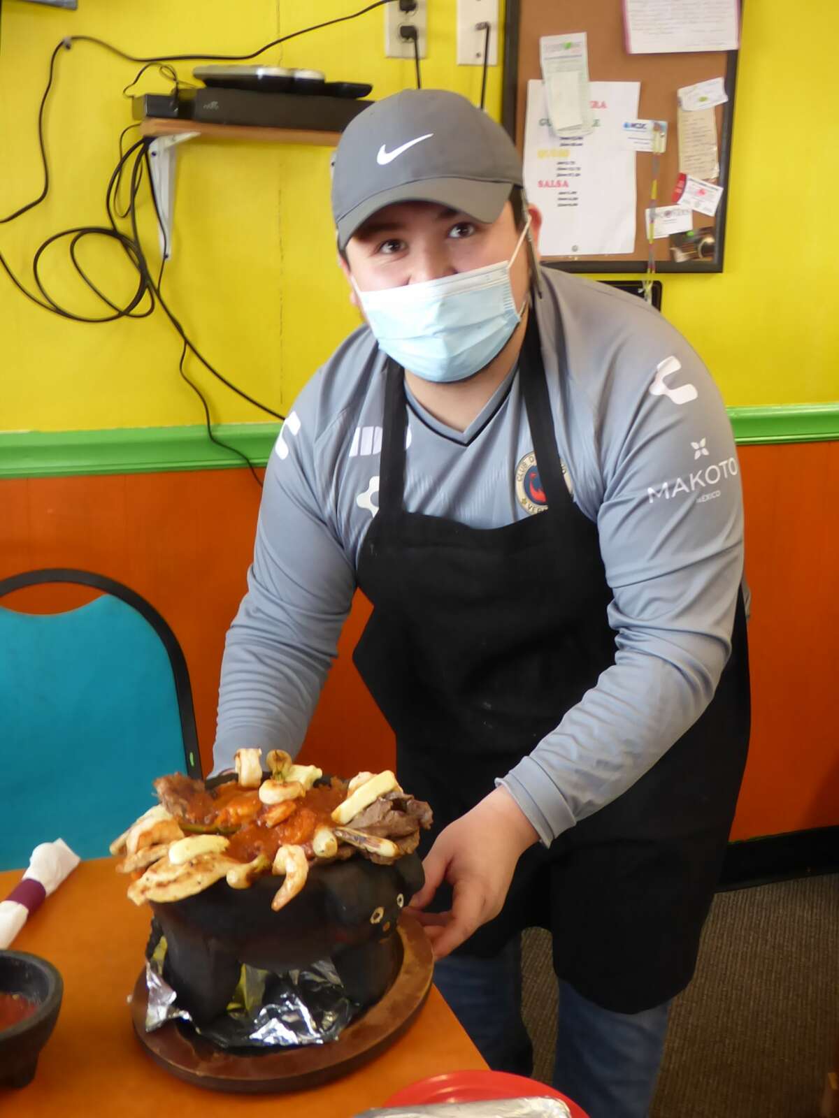 La Riviera Mexican Grill manager Austin Vela presents his molcajete, one of a number of new items the restaurant debuted since the onset of the pandemic.