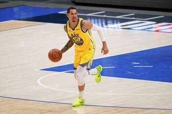 Golden State Warriors' Juan Toscano-Anderson handles the ball during an NBA basketball game against the Dallas Mavericks in Dallas, Thursday, Feb. 4, 2021. (AP Photo/Tony Gutierrez)