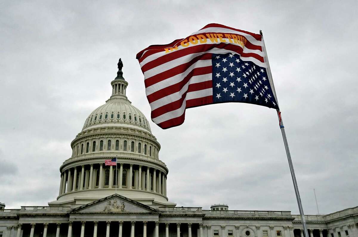 An upside down flag waves in front of the U.S. Capitol on Jan. 6, 2021.