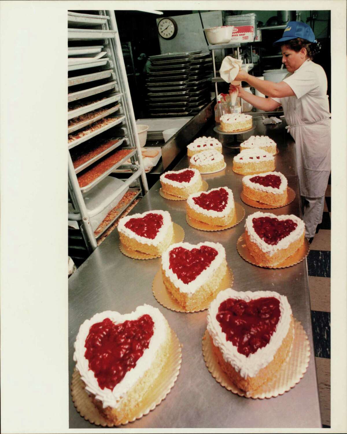Rosa Gonzalez, cake decorator at Nadler's Bakery prepares strawberry shortcakes for Valentine's Day.