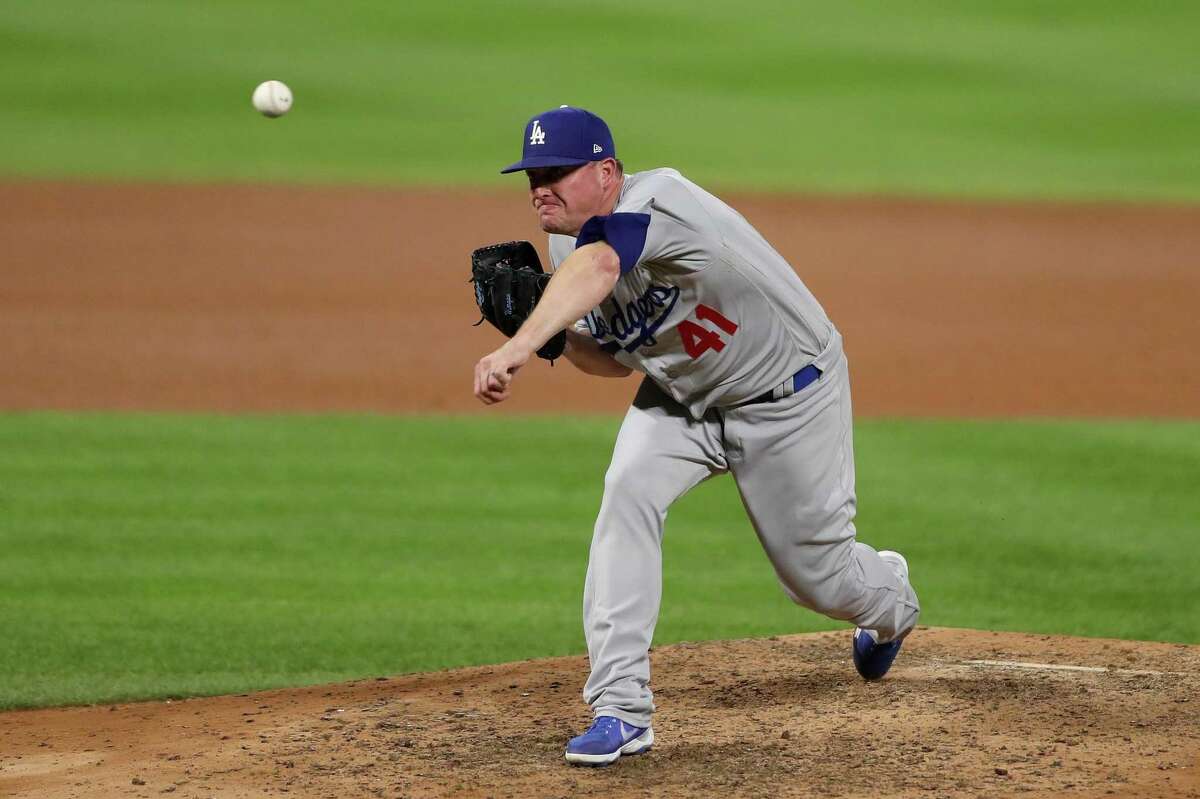 DENVER, COLORADO - SEPTEMBER 19: Pitcher Jake McGee #41 of the Los Angeles Dodgers throws in the eighth inning against the Colorado Rockies at Coors Field on September 19, 2020 in Denver, Colorado. (Photo by Matthew Stockman/Getty Images)