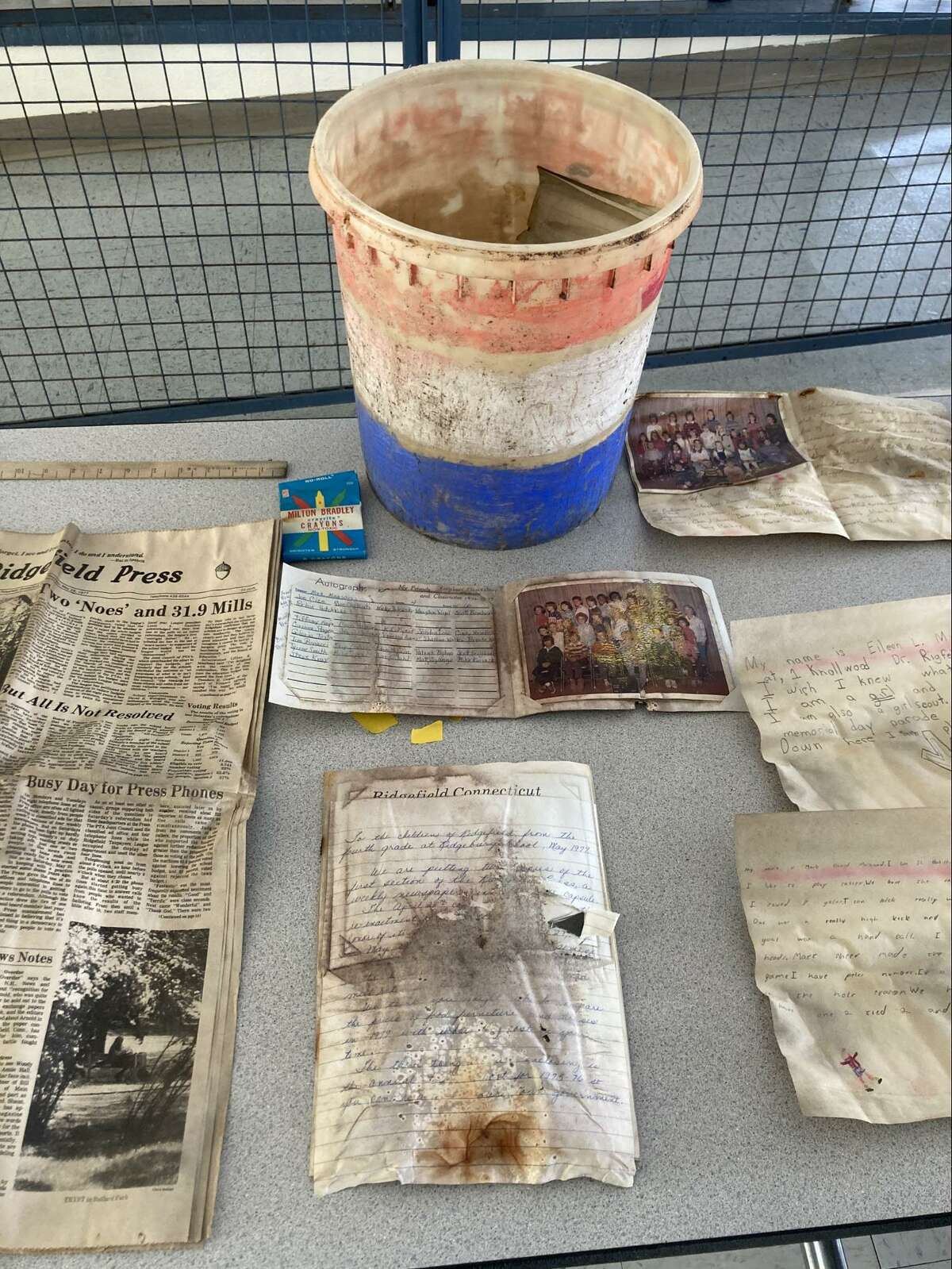 Some of the objects found in the container, including a copy of the Ridgefield Press