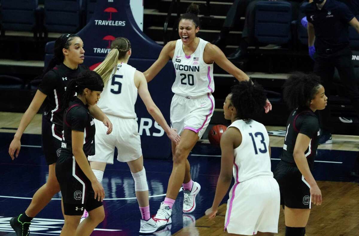 UConn forward Olivia Nelson-Ododa (20) and guard Paige Bueckers (5) react after defeating South Carolina in overtime on Monday in Storrs.