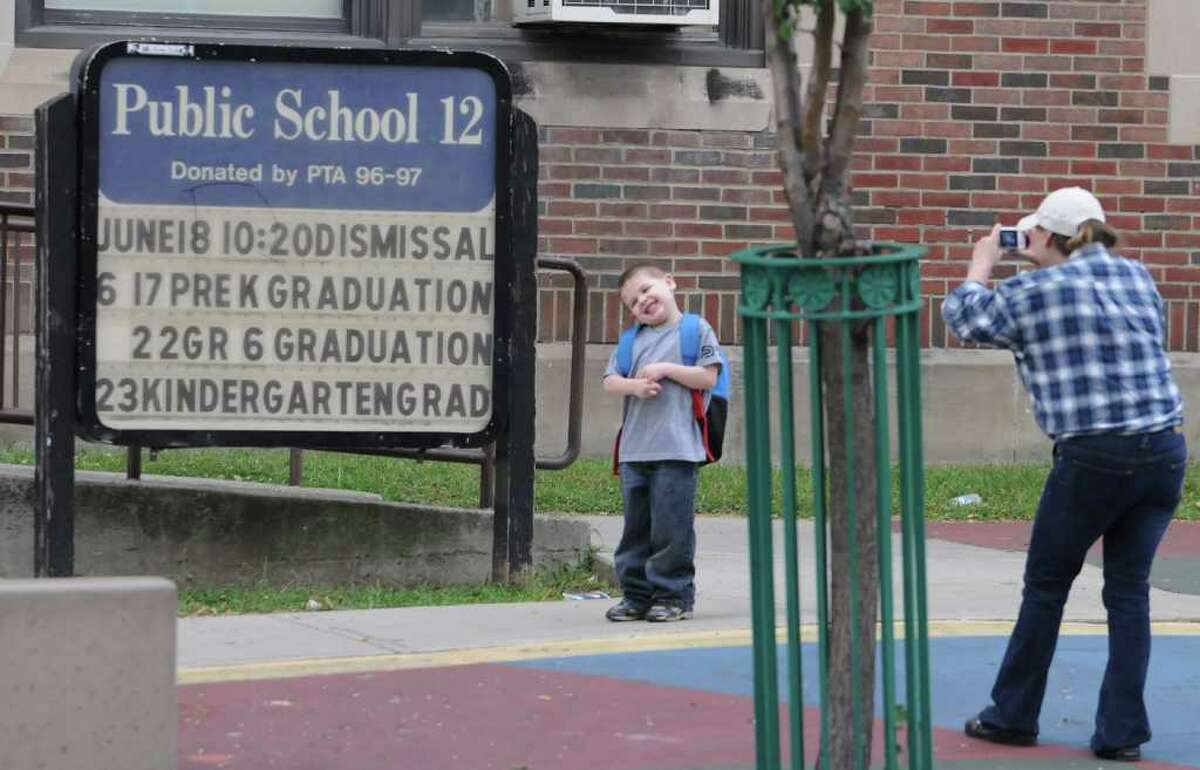 Missy Decker of Troy takes a photo of her son, Jason,5, as students arrive to first day of classes at School 12 in Troy Monday, Sept. 7, 2010. (Lori Van Buren / Times Union)