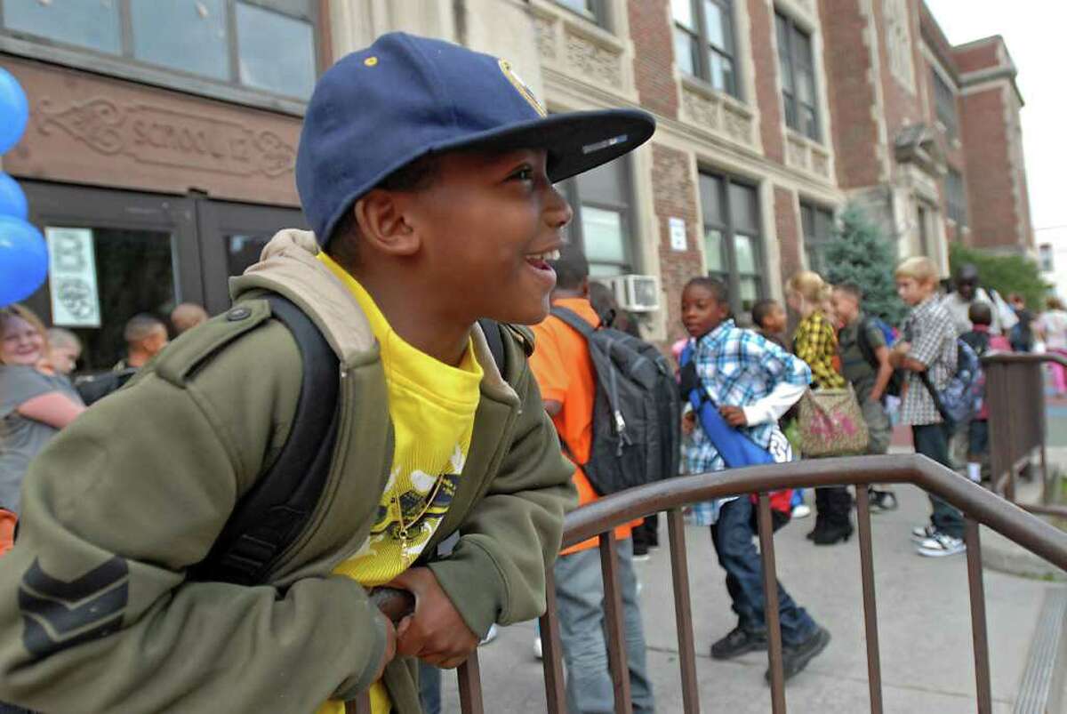 Kiam Vaughan,10, of Troy watches as students arrive for first day of classes at School 12 in Troy on Tuesday, Sept. 7, 2010. (Lori Van Buren / Times Union)
