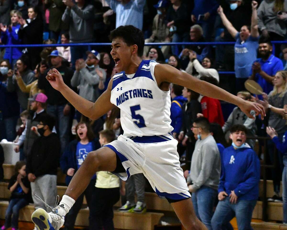 Olton's Israel Santillan celebrates the final seconds of the 13th-ranked Mustangs' 55-50 win over 15th-ranked Farwell to win the District 3-2A championship on Tuesday in Olton Memorial Gymnasium.