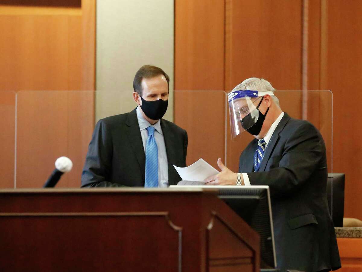 Attorney Randy Sorrels (left) wears a mask and Attorney Kent Adams wears a face shield in Harris County Judge Rabeea Sultan Collier's courtroom Wednesday, Feb. 3, 2021, in Houston.