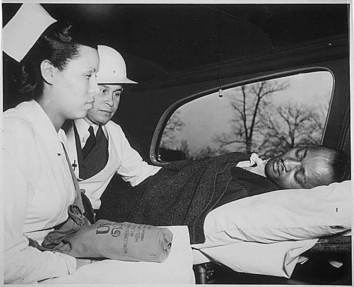 After receiving first aid treatment in a practice raid in Washington, D.C., an air-raid "victim" was taken to the hospital by a Medical Corps of the Office of Civilian Defense. The physician is Dr. Charles Drew (middle). (Courtesy photo/National Archives)