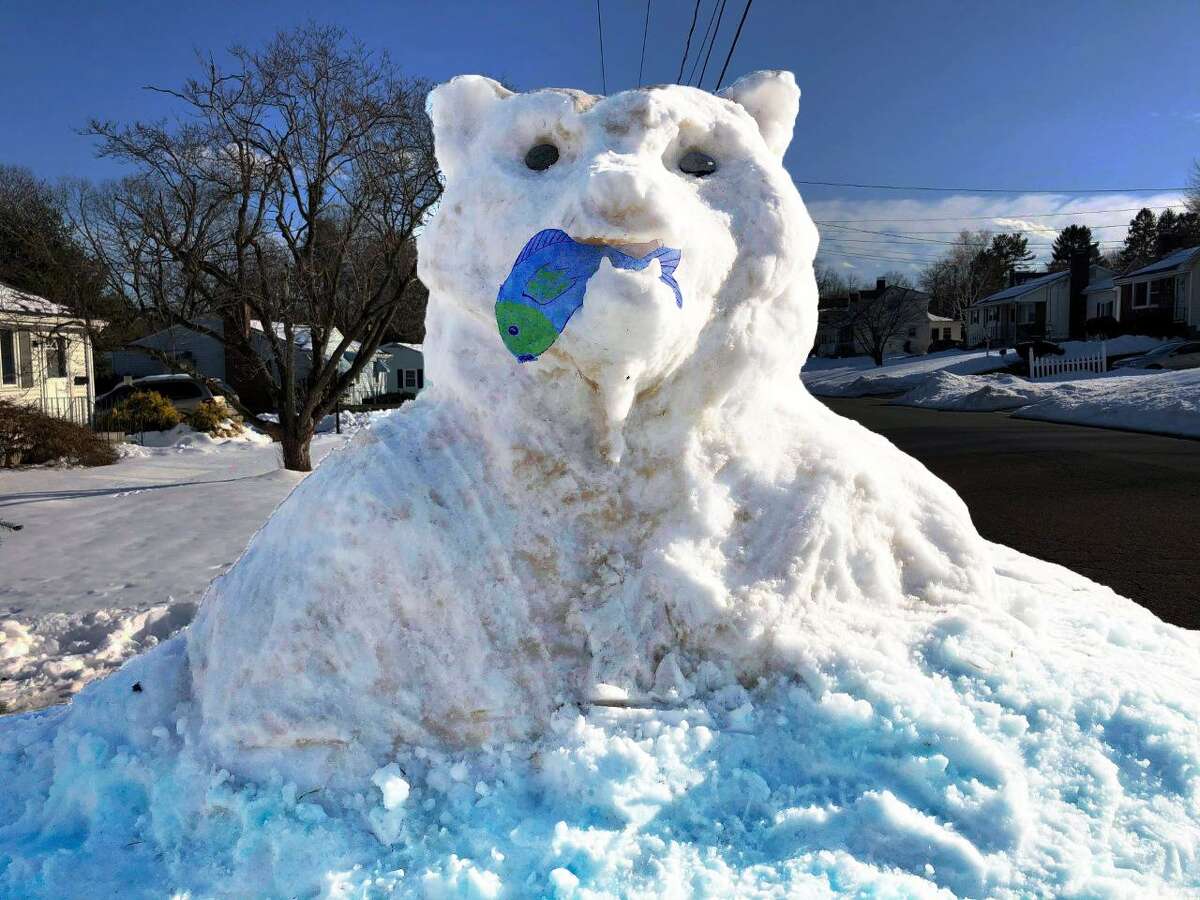 The “Mama Bear” snow sculpture, created over the past weekend by family and friends of Karen Terrio-Malave, guards their property on Fowler Avenue in Middletown.