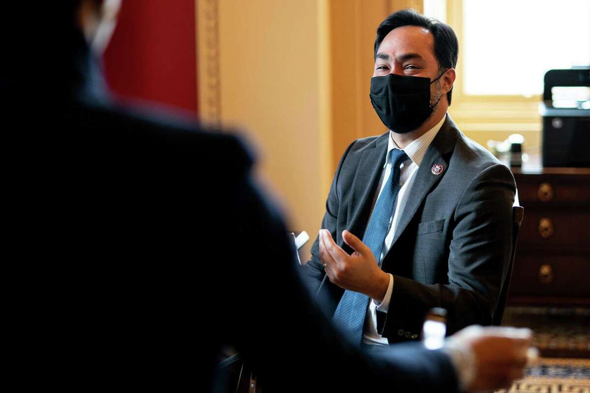 House impeachment manager Rep. Joaquin Castro (D-Texas) speaks with an aide on the second day of the second Senate impeachment trial for former President Donald Trump at the Capitol in Washington on Wednesday, Feb. 10, 2021. (Erin Schaff/The New York Times)