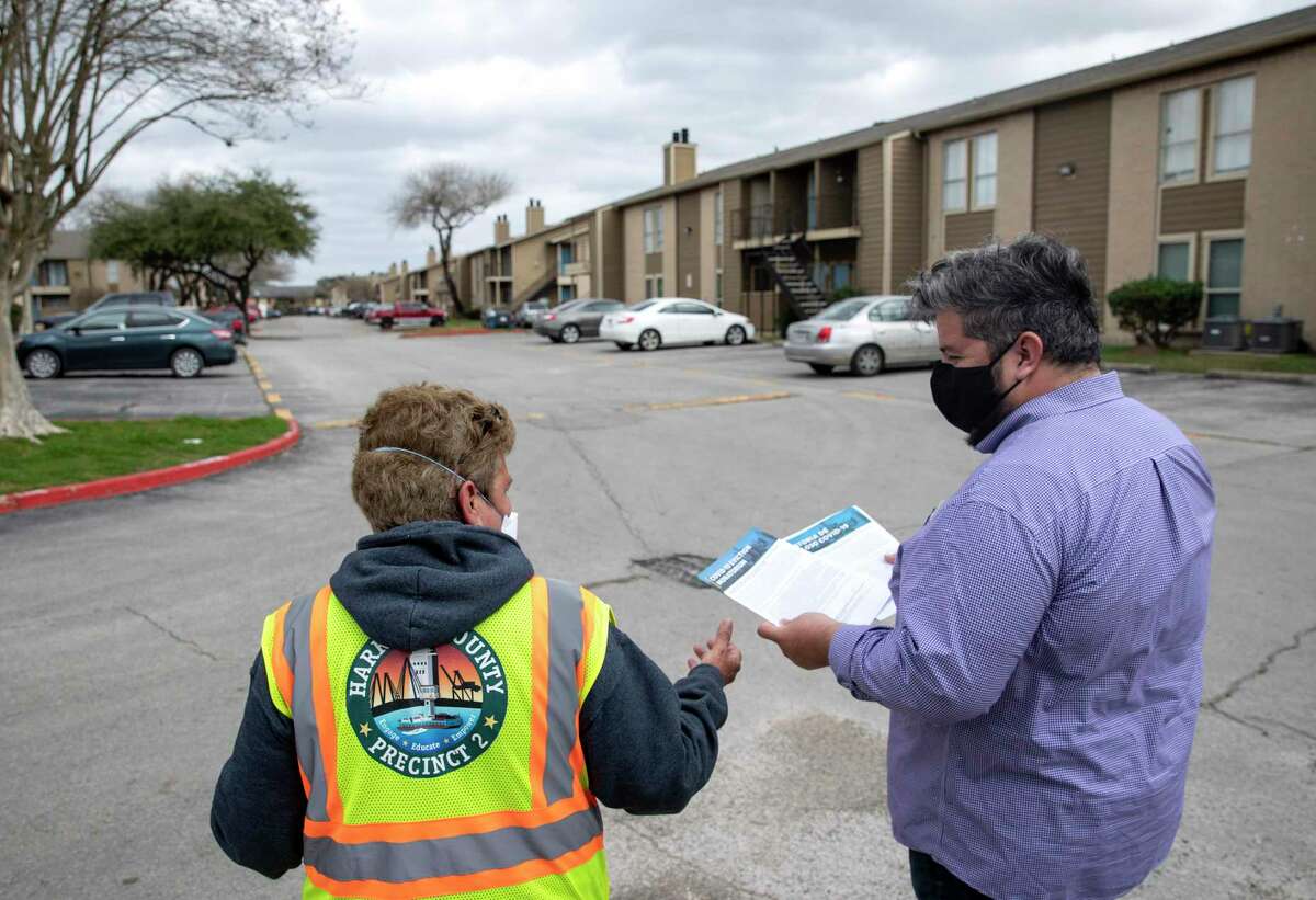 Francisco Castillo, left, and Selina Valdez distribute information about tenants' rights as they relate to eviction proceedings and the COVID-19 pandemic Thursday, Feb. 4, 2021, at Timber Ridge Apartments in Houston.