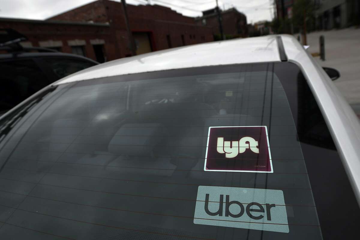 A file photo shows a car with Uber and Lyft stickers during a car caravan protest on Aug. 6, 2020, in Los Angeles.